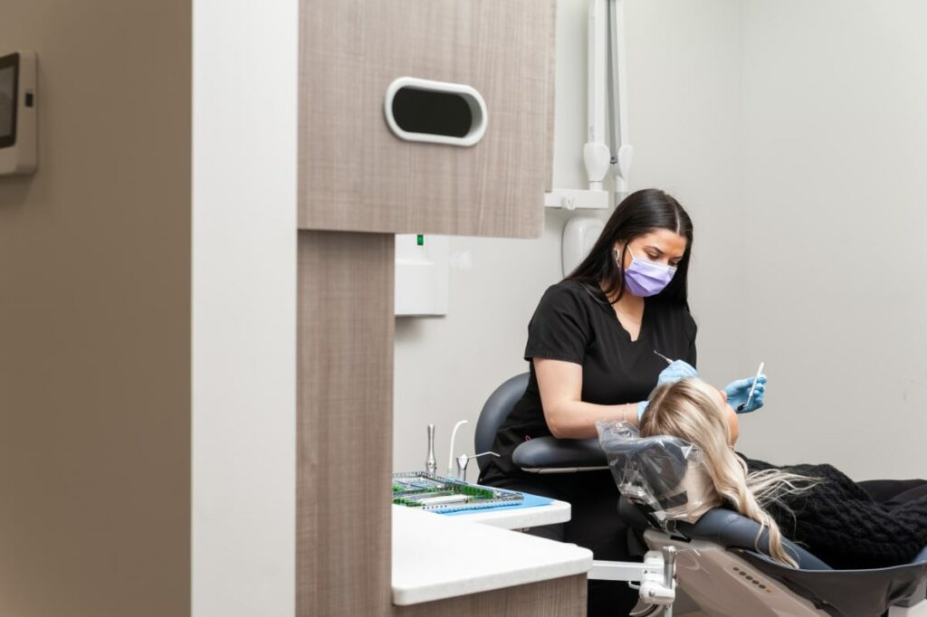 A girl dentist at Blue Bridge Dental conducting a gum disease treatment